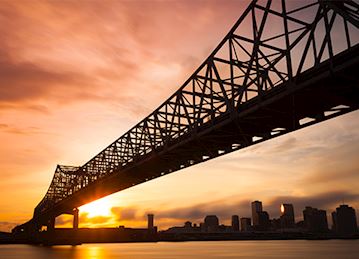 New Orleans skyline and bridge at dusk